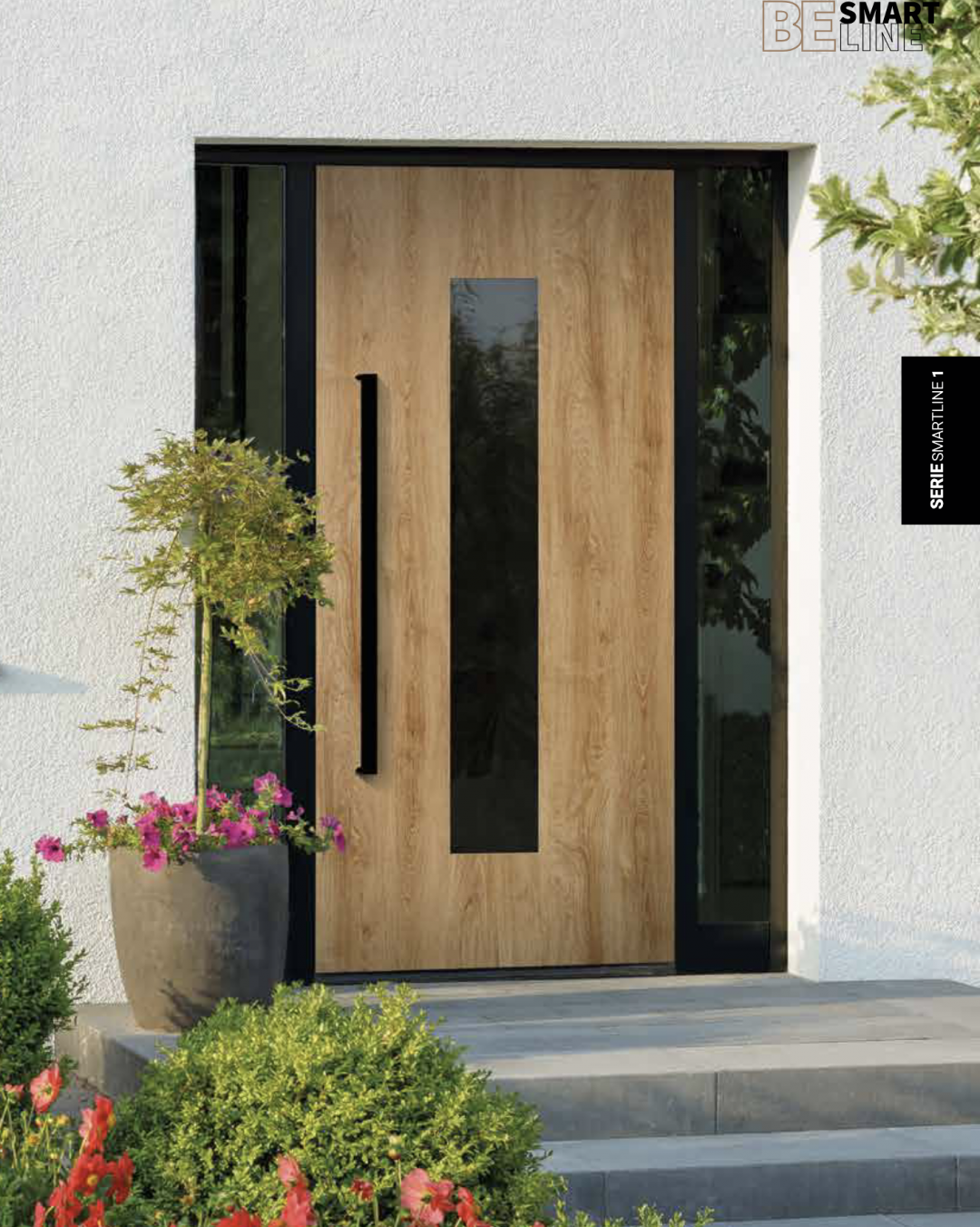 Holztür mit Klarglas und schwarzen Deails an einem Haus, Büsche und Blumen im Vordergrund